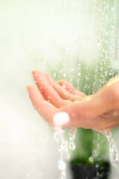 istock Close up female hand in the shower. 1409122655