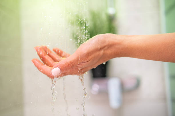 istock Close up female hand in the shower. 1409122663