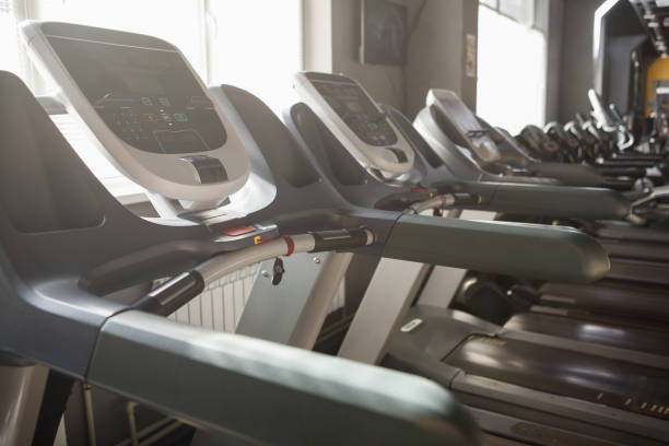 istock Empty treadmills in a row at sports studio 1409124352