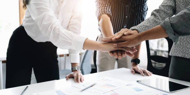 istock Close up young business people putting their hands together. Stack of hands. Unity and teamwork concept. 1409126079