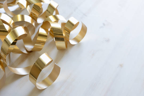 istock Gold ribbon streamers on white 1409127773