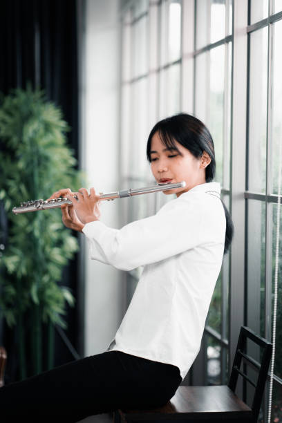 istock Young woman flutist performs on a musical instrument 1409129988