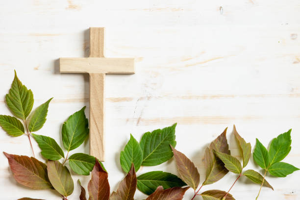 istock Cross with red and green leaf border on white 1409131031