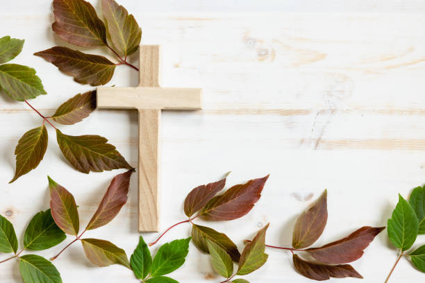 istock Wood cross and autumn leaf border on white 1409131035