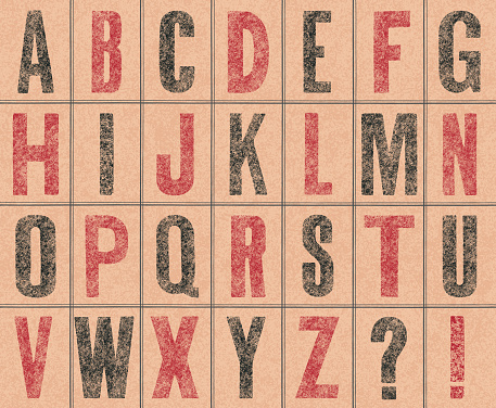 Stamped old capital letters on brown paper
