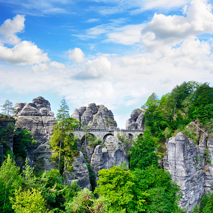 The Bastei Bridge was constructed to link several rocks for the visitors in 1851, Germany. Composite photo