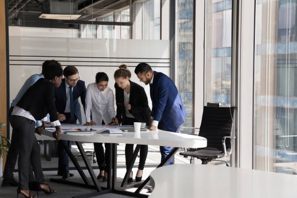istock Group of multiethnic teammates gathered for project financial stats discussion 1409136589