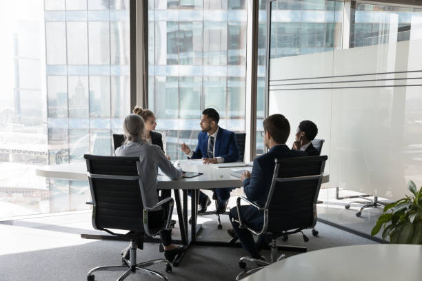 istock Five multi ethnic business people negotiating in modern boardroom 1409136751