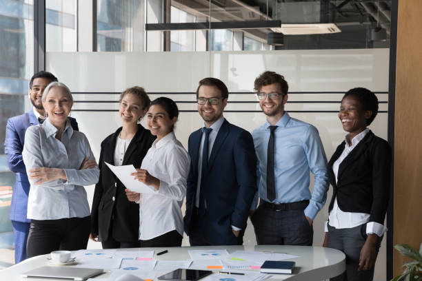istock Multiethnic employees smile for camera pose in modern office boardroom 1409137492