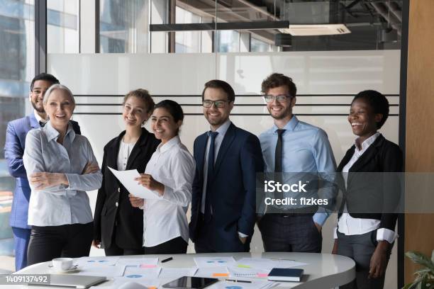 Multiethnic Employees Smile For Camera Pose In Modern Office Boardroom Stock Photo - Download Image Now