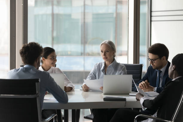 istock Diverse people take part in group meeting in office boardroom 1409137548