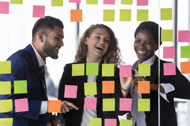 istock Overjoyed diverse colleagues work together review tasks written on notes 1409137557