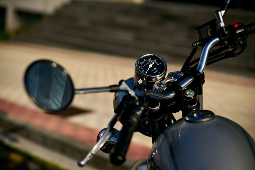 Handlebar, tank and rearview mirror of unrecognizable classic motorcycle. High quality photo