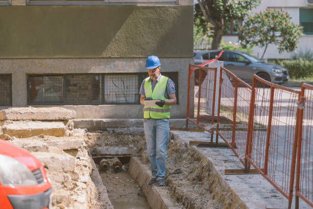istock Technician inspecting heating pipeline trench in the city 1409141584