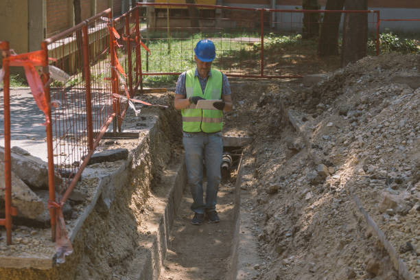 istock Technician inspecting heating pipeline trench in the city 1409141589