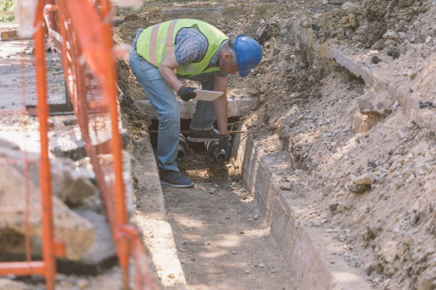 istock Technician inspecting heating pipeline trench in the city 1409141590
