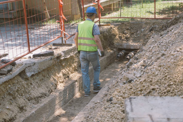 istock Technician inspecting heating pipeline trench in the city 1409141593