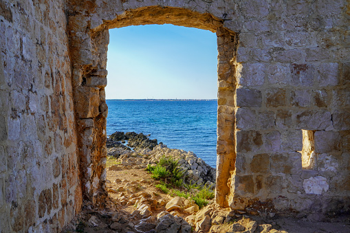 A stone door with a view of the Adriatic Sea\nD.H