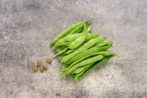 Green beans cut on rustic wood table background on cutting board