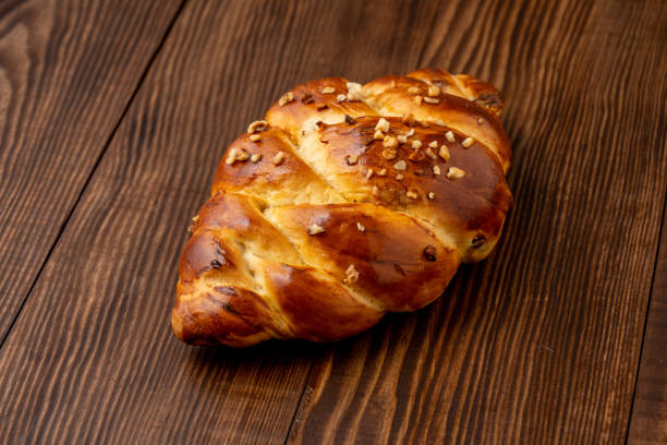 istock Homemade braided Challah bread on vintage background 1409144182