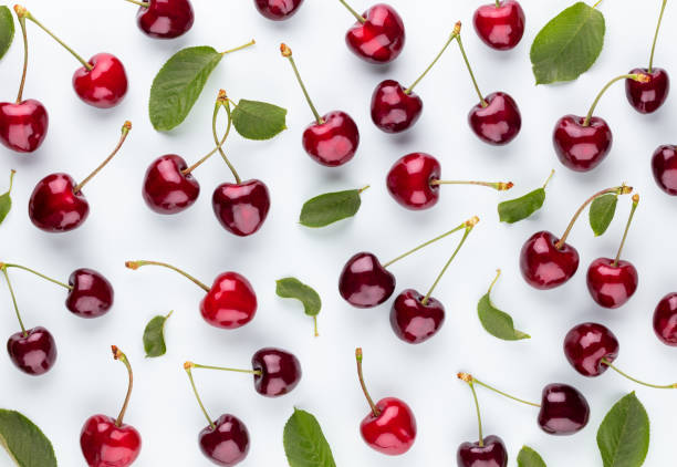 istock Cherry berries on a pastel background top view.  Background with a cherry on a sprig, flat lay 1409144719
