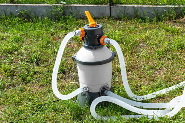istock Large sand pump for garden pool water purification, transparent water hoses visible. 1409144903
