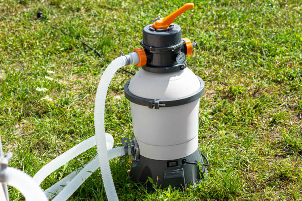 istock Large sand pump for garden pool water purification, transparent water hoses visible. 1409145474