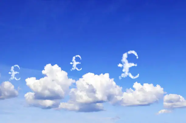 Photo of Money making. Great Britain pound sterling sign in the clouds. Cloud shaped as GBP currency symbol