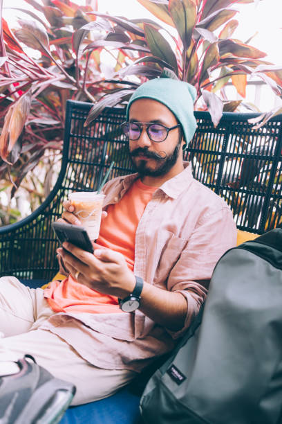 istock A Serious Handsome Bearded Businessman With Glasses Texting On His Mobile Phone While Drinking Coffee At The Cafe 1409150815
