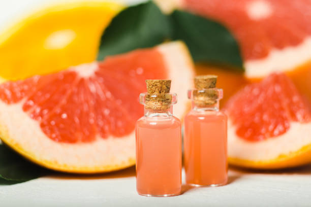 istock Orange essential oil in bottles, grapefruits, oranges on background. 1409151150