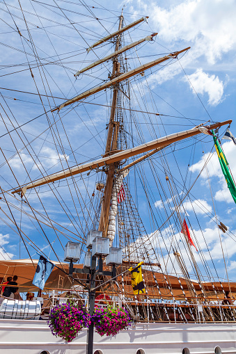 Hugh mast and complex rigging rise above the deck of a Tall Ship moored at the Baltimore Inner Harbor