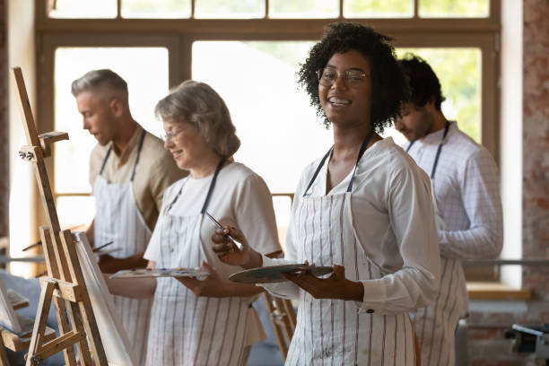 istock African woman engaged in art-class, pose smile look at camera 1409155376