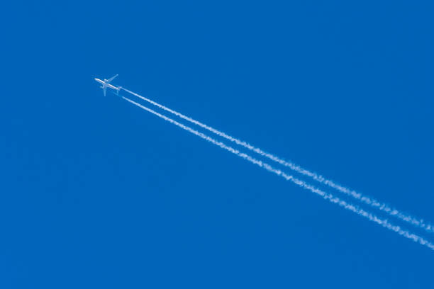 istock Silhouette of an airplane in the blue sky without clouds. 1409165610