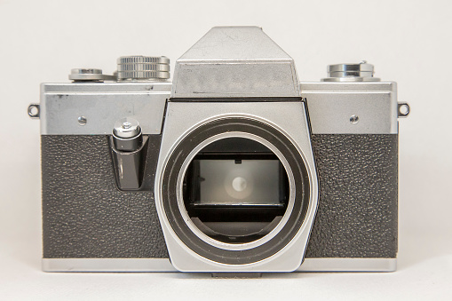 An old medium format camera with bellows lens from the 1940-50s on white background.
