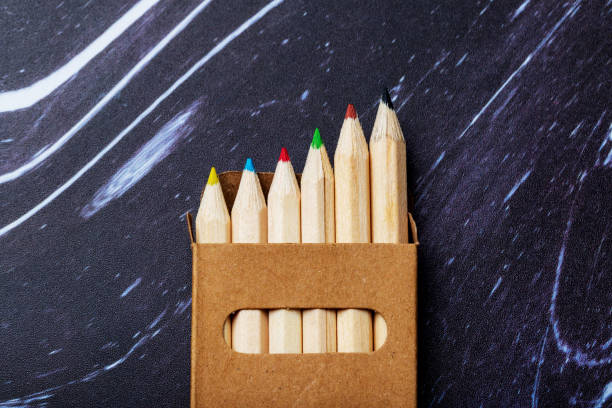 istock Wooden colored crayons on a dark background. 1409166351