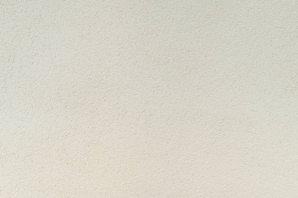 istock Texture of light beige decorative plaster, background. 1409168312
