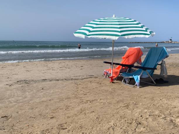 istock Two beach chairs with sun umbrella on beach 1409172259