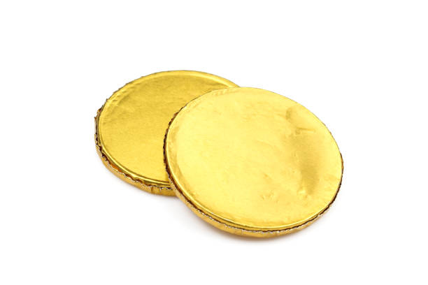 chocolate sweets wrapped in yellow foil. fake dessert coins - chocolate coins imagens e fotografias de stock