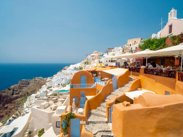 Santorini island, Greece. Oia town traditional white houses and churches with blue domes over the Caldera, Aegean sea.