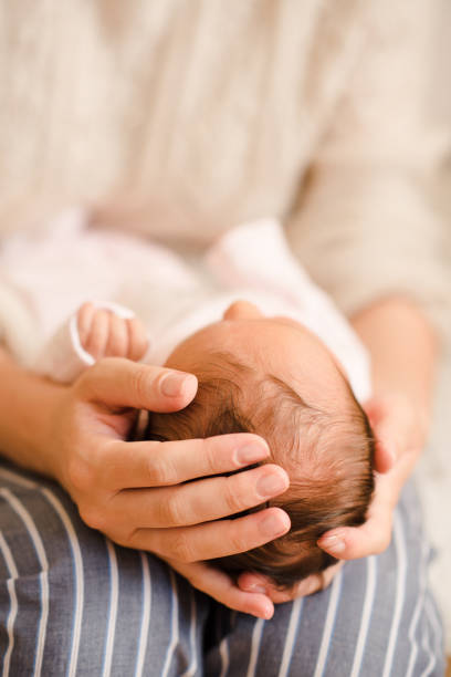 istock Woman holding sleeping baby on hands 1409177172