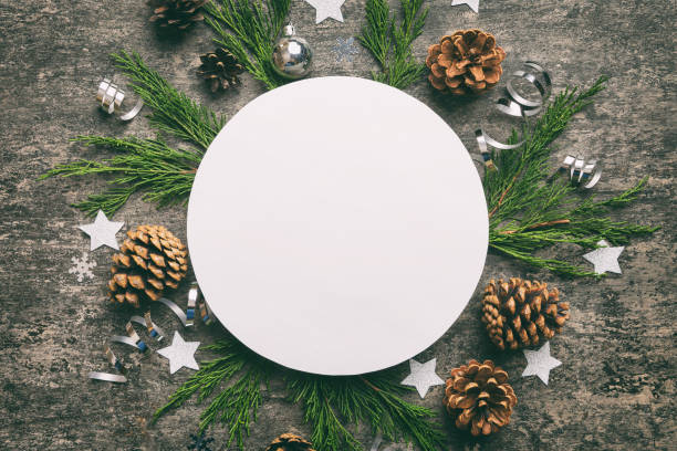istock Flat lay Christmas composition. Round Paper blank, pine tree branches, christmas decorations on Colored background. Top view, copy space for text 1409177273
