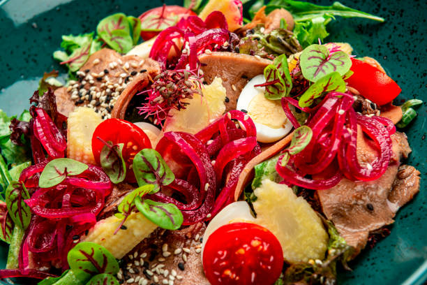 istock Beef tongue salad with fresh vegetables, pickled onions and mini corn 1409179443