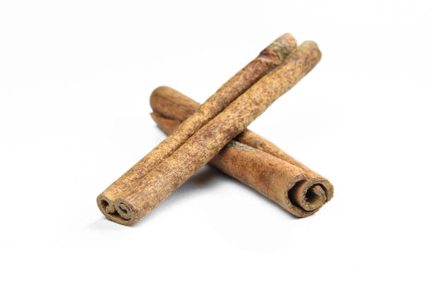 istock Brown cinnamon sticks isolated on white background. Aromatic food ingredients 1409181218