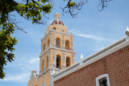 Parroquia de Santa María de la Natividad, bell tower of a traditional mexican Church cathedral in the zocalo square center of the magic town Atlixco, Puebla, Mexico