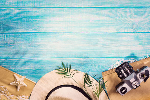 Top view of summer beach accessories on marine blue planks