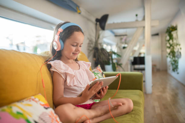 istock Little girl playing video games on tablet 1409188727