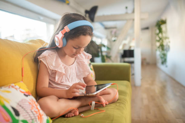 istock Little girl playing video games on tablet 1409188729