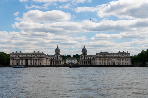Greenwich, United Kingdom - June 13, 2022: Royal Greenwich as seen across the Thames river from the Isle of Dogs