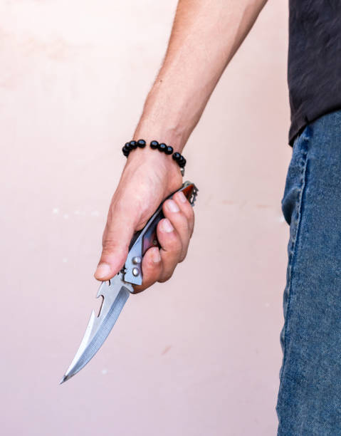istock man holding pocket knife in hand 1409192701