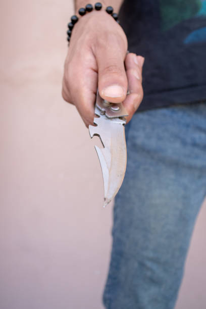 istock man holding pocket knife in hand 1409192702